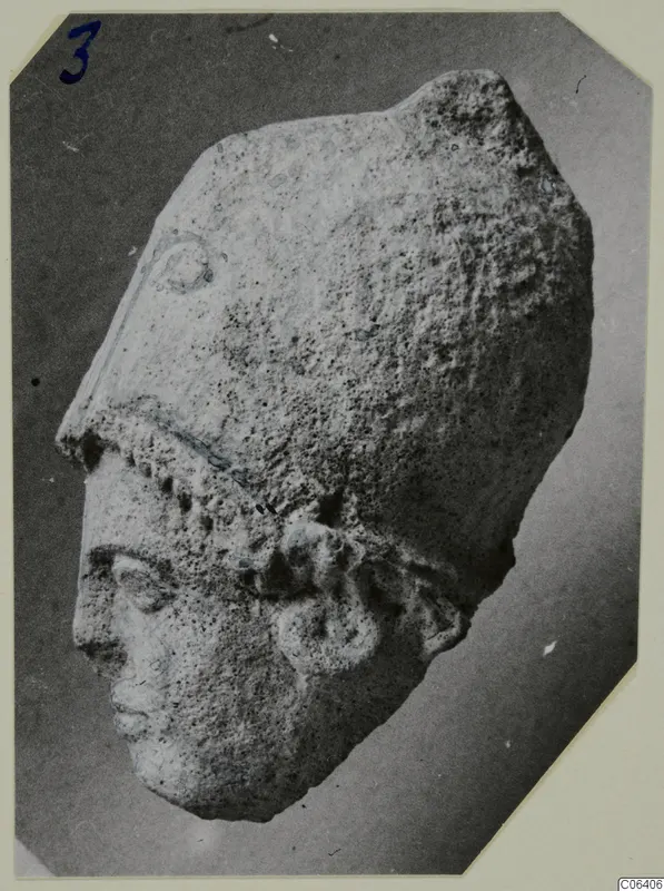 Limestone head from Vouni, photographed at an angle against a dark ground.