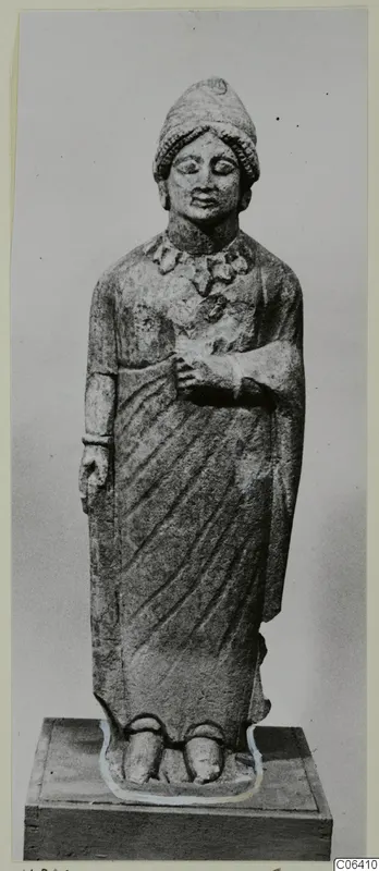 Standing limestone statue from Vouni, shown on a wooden plinth