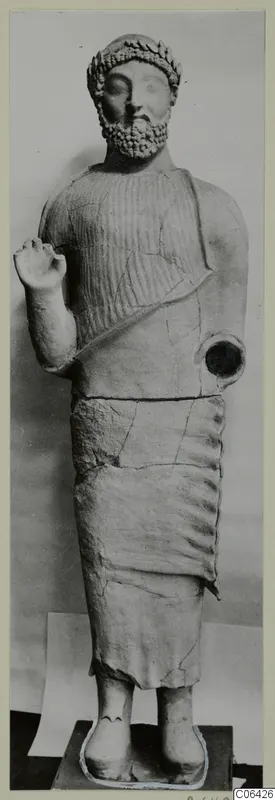 Statue of a standing bearded man with a leafy band in his hair and one fist raised, Cypro-Greek II