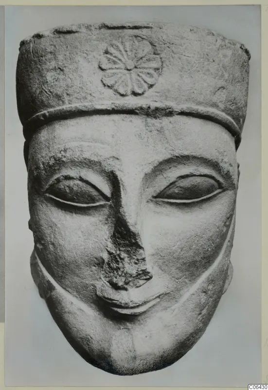 Limestone head of a figure with a tall cylindrical headdress and rosette, front view, Proto-Cypriote statue