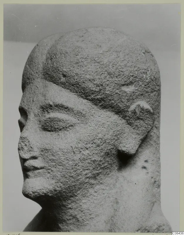 Limestone sculpture of a head from Kition, turned to the left, with narrowed eyes and a broad band across the brow