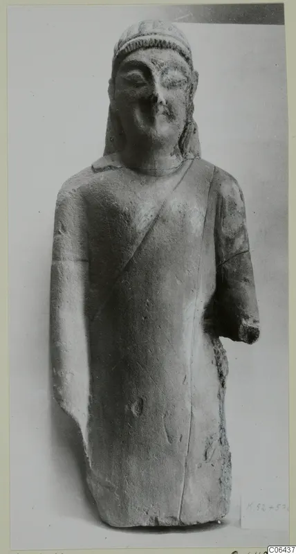 Limestone statuette from Kition of a standing figure in a long garment with a cap-like headdress