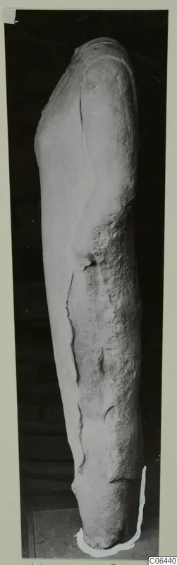 Limestone sculpture fragment from Vouni, standing upright against a dark background.