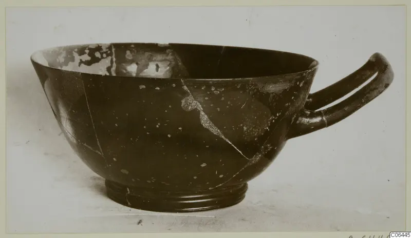 Black glazed bowl with a ring foot and one horizontal handle, a find from Vouni