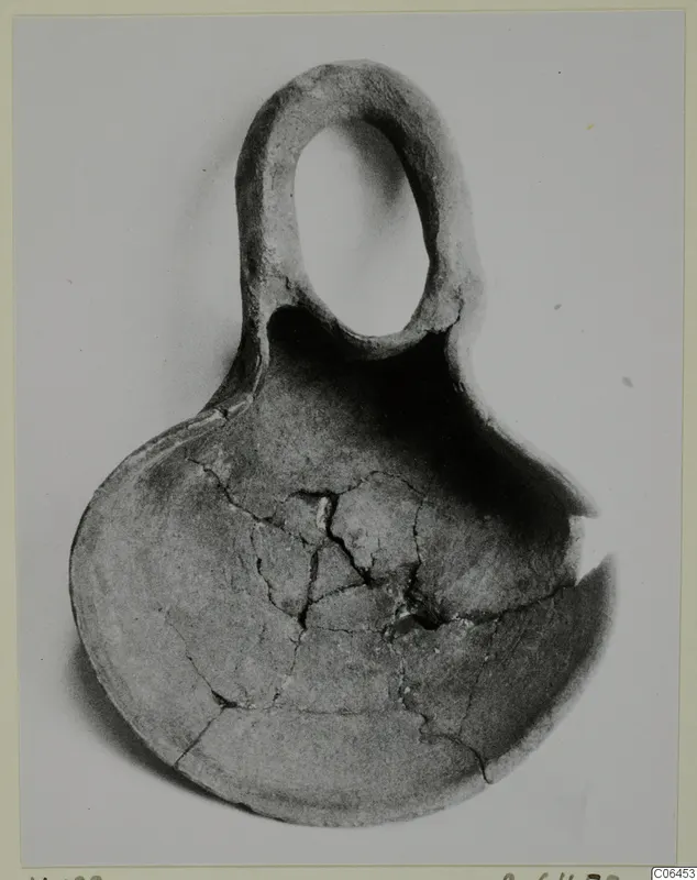 Terracotta lamp from Vouni with a tall loop handle and a broad bowl-shaped body