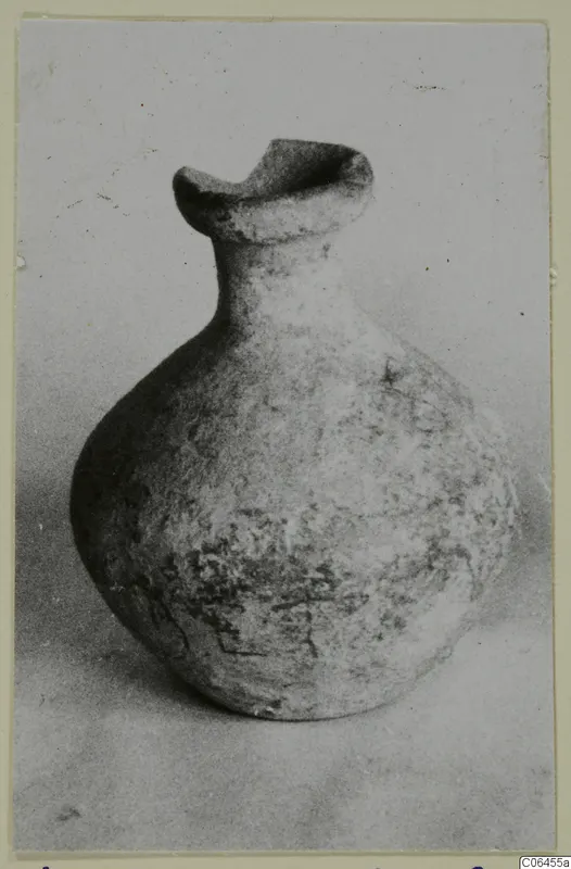 Plain White VI pottery vessel with a flared spout-like rim and rounded body, photographed on a plain background