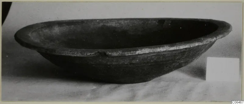 Coarse ware bowl from Vouni, shown from the side on a pale surface.