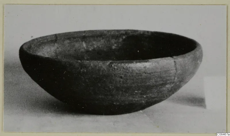 Pottery coarse ware bowl from Vouni, shown from the side on a pale surface