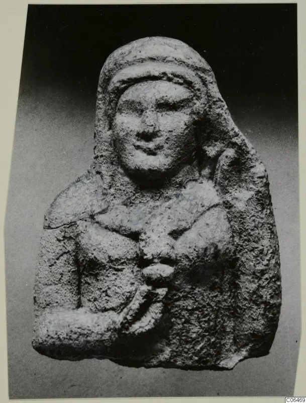 Limestone figurine of a bust with a hooded head and one arm bent across the chest, from Vouni