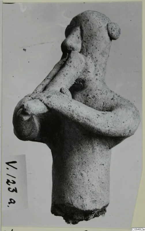 Terracotta figurine of a human figure with arms crossed over the chest, shown in side view, from Vouni.