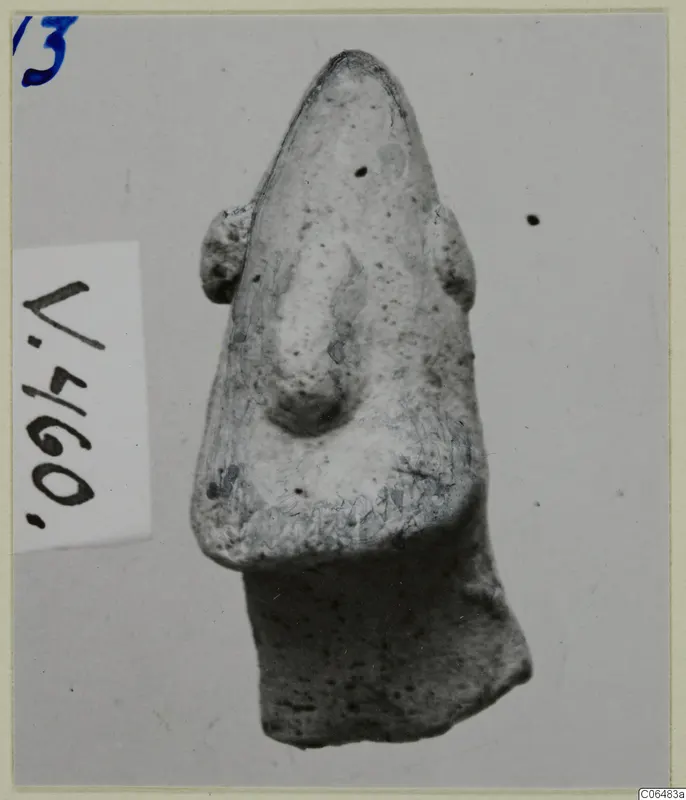 Terracotta figure fragment from Vouni with a pointed top, a raised central ridge and small side projections