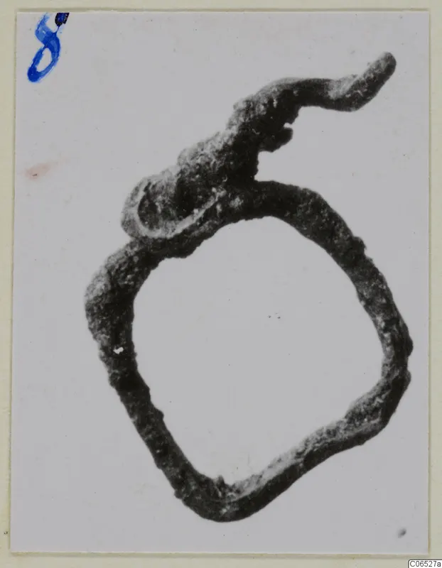 Corroded bronze ring fragment from Vouni with a bent, tapering extension at the top