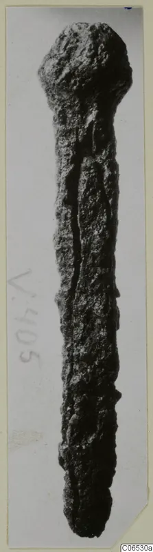 Corroded iron nail from Vouni, shown upright on a photo mount