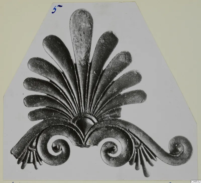 Bronze fragment of a fan of tongue-shaped leaves above spiral scrolls, from Vouni