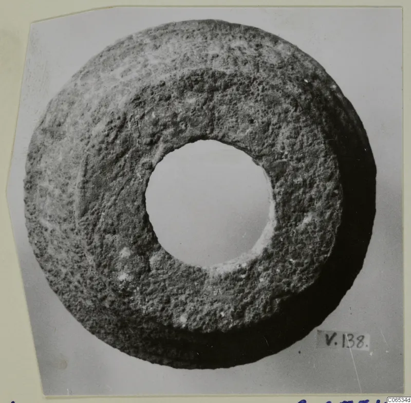 Ring-shaped object with a large central hole, photographed face-on against a plain background.