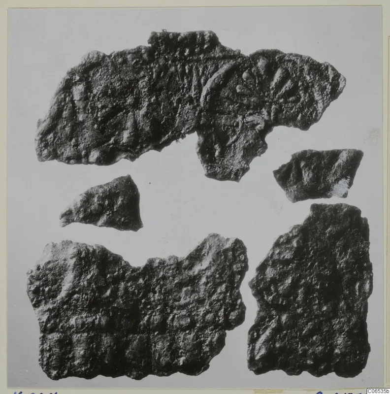 Five fragments of corroded bronze sheet with raised ridges and rounded bosses, from Vouni.