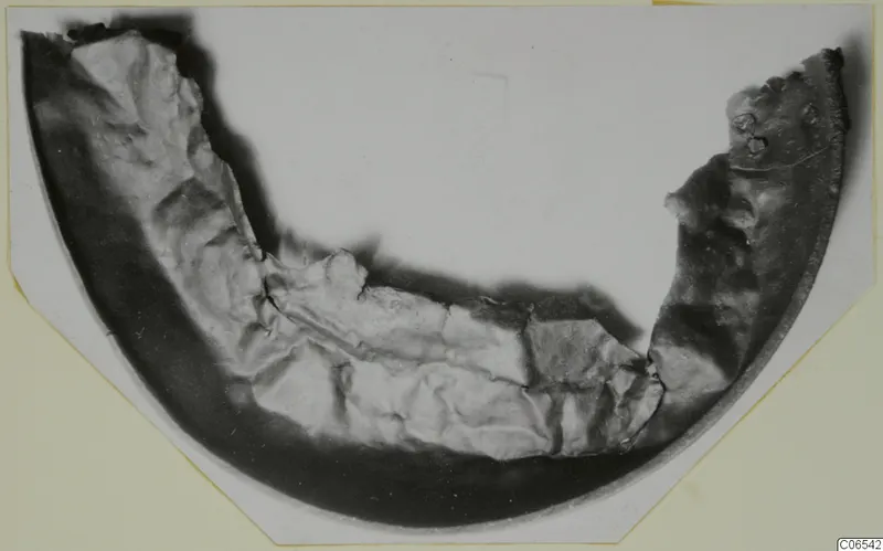 Curved fragment of a bowl from Vouni, with a dark outer band and a pale, rough inner surface