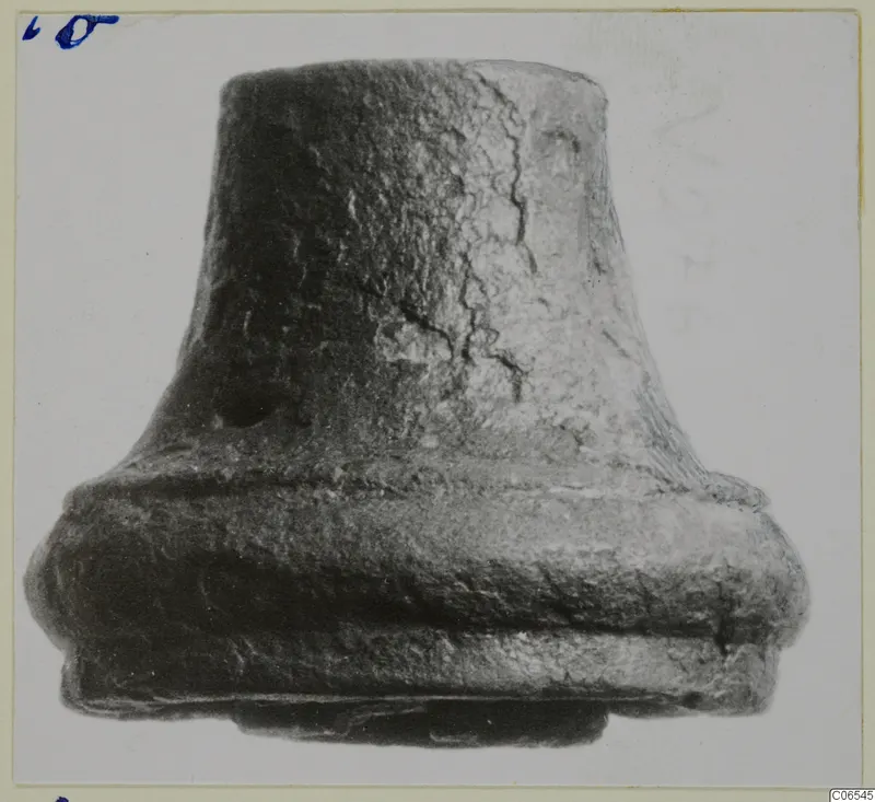 Bronze fragment from Vouni with a tapering upper part and a broad stepped collar at the base