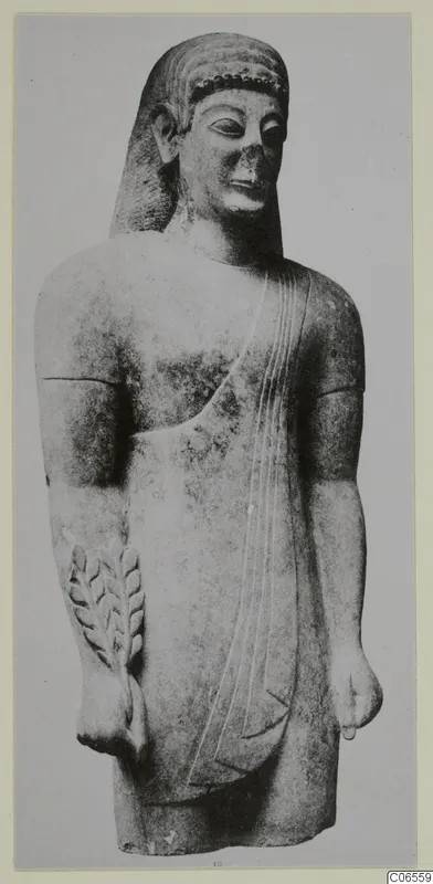Limestone Neo-Cypriote statue of a standing figure with a leafy branch in relief, photographed from the front