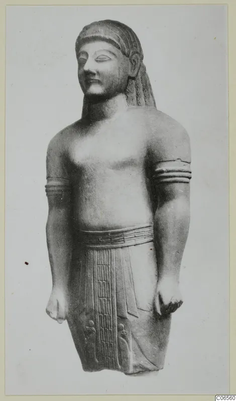 Limestone Neo-Cypriote statue of a standing figure with arm bands and a belt.