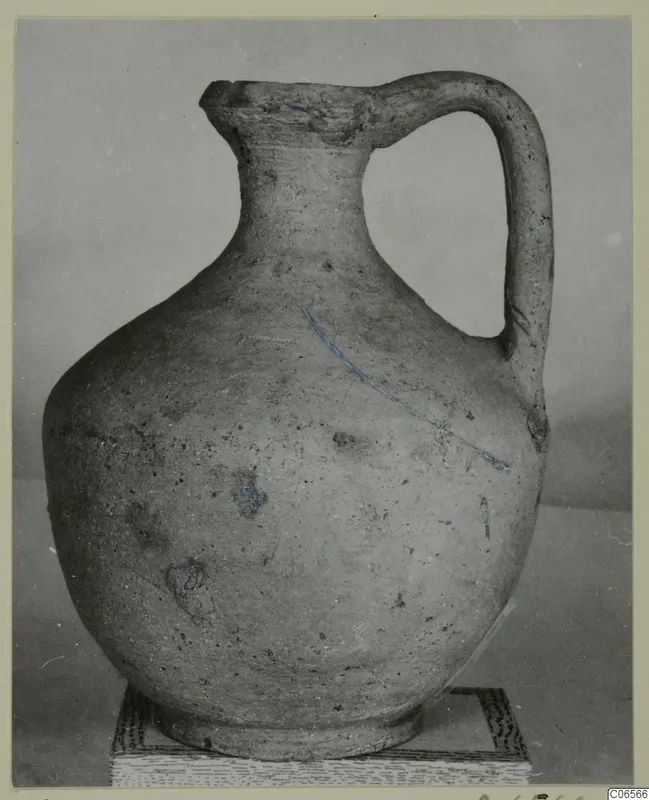Pottery Plain White VII jug with one handle and a rounded body, shown on a stand