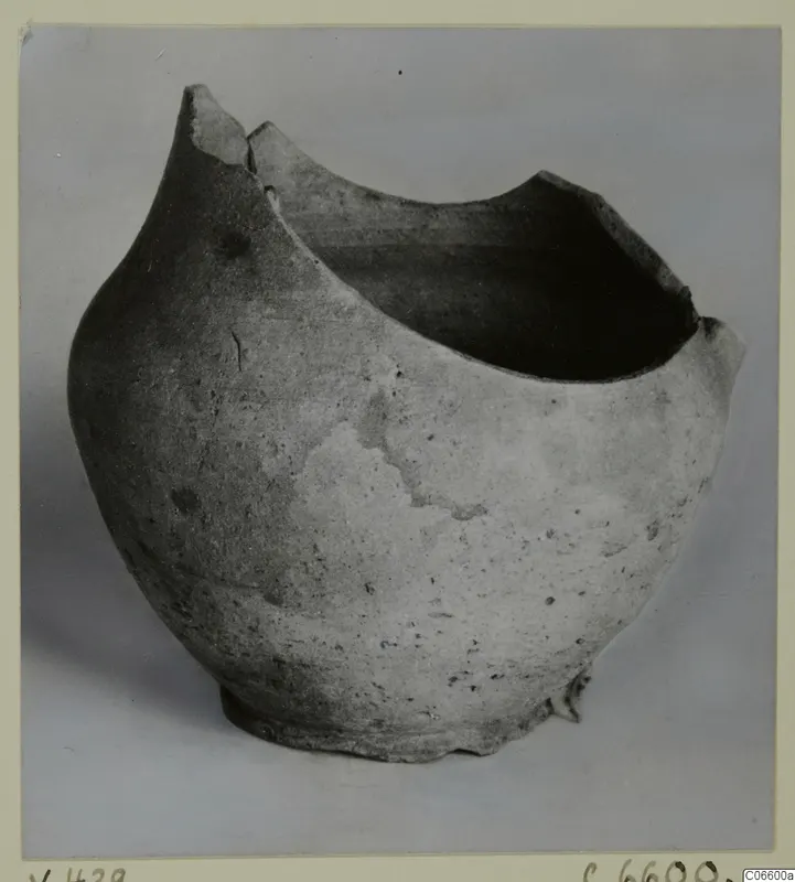 Pottery Plain White VII jug, broken at the rim, photographed in side view against a grey backdrop.