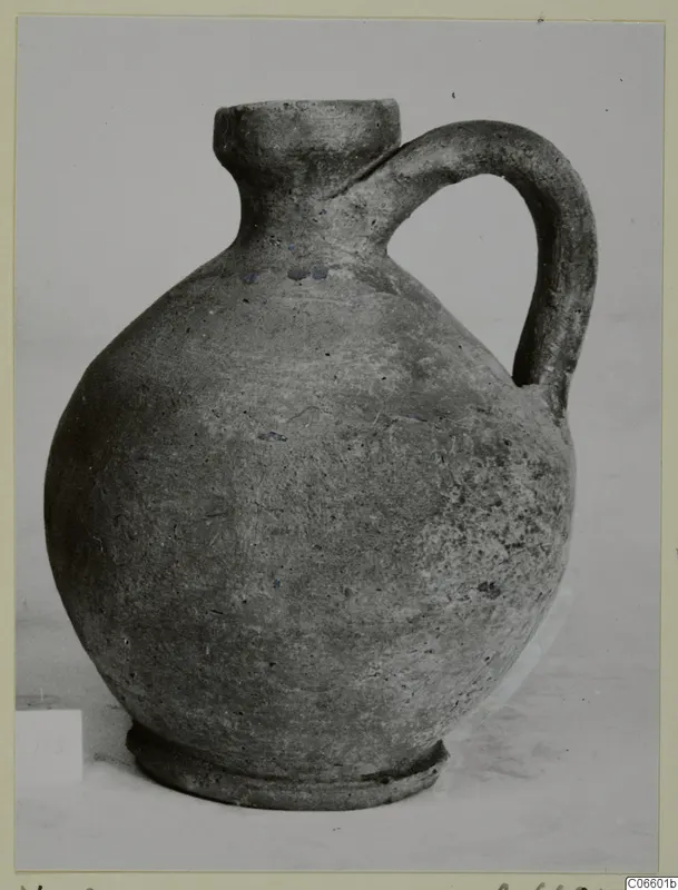 Pottery Plain White VII jug from Vouni, a round-bodied jug with a single handle and a narrow neck.