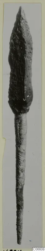 Bronze arrowhead from Vouni, photographed upright against a grey background