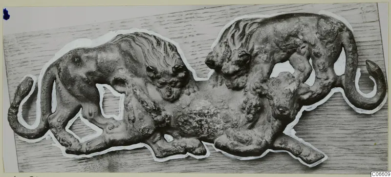 Bronze relief of two maned animals with curling tails, one overlapping the other, from Vouni.