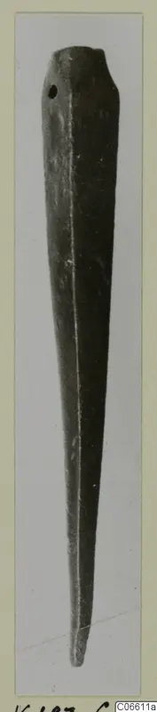 Bronze spearhead, a long tapering metal object with a small hole near the upper end, shown on a card mount