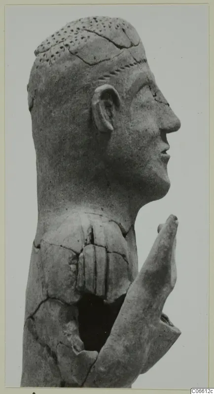 Terracotta statue of a man's head in profile with a raised hand, from Ayia Irini