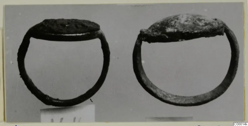 Two silver rings with flat oval tops, photographed side by side on a grey background, from Vouni