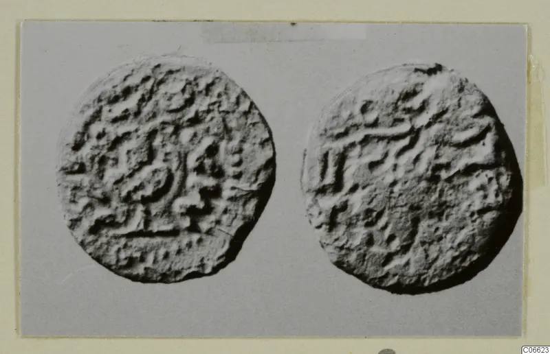 Two round objects with raised, irregular marks on their faces, from Vouni
