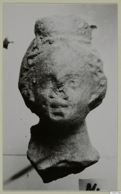 Terracotta figurine head with a tall headdress and wavy side hair, from Mersinaki