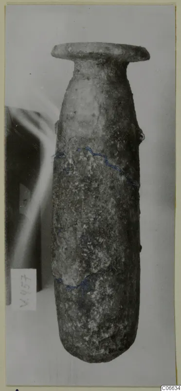Alabaster alabastron from Cyprus: a tall, narrow stone vessel with a flared rim, photographed upright against a pale background
