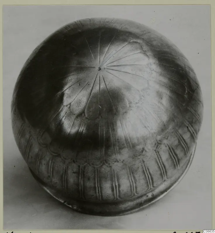 Silver rounded vessel from Vouni with incised radiating lines on its top and vertical grooves around the base