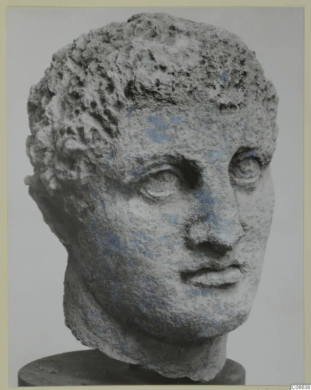 Carved limestone head with short curly hair and traces of blue paint, from Mersinaki
