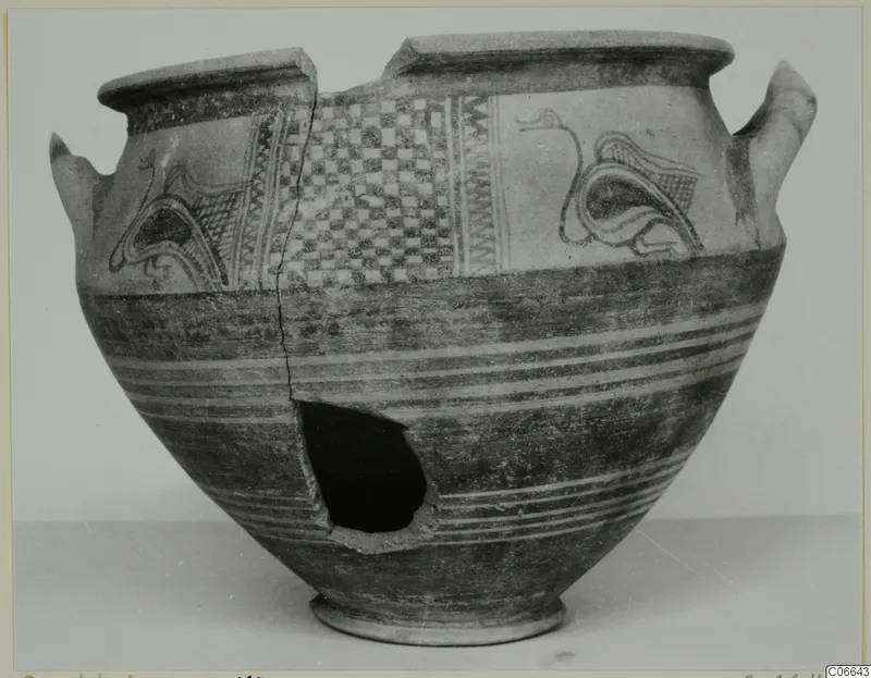 White Painted wheel-made pot with bird-like motifs and a checkerboard panel, side broken open