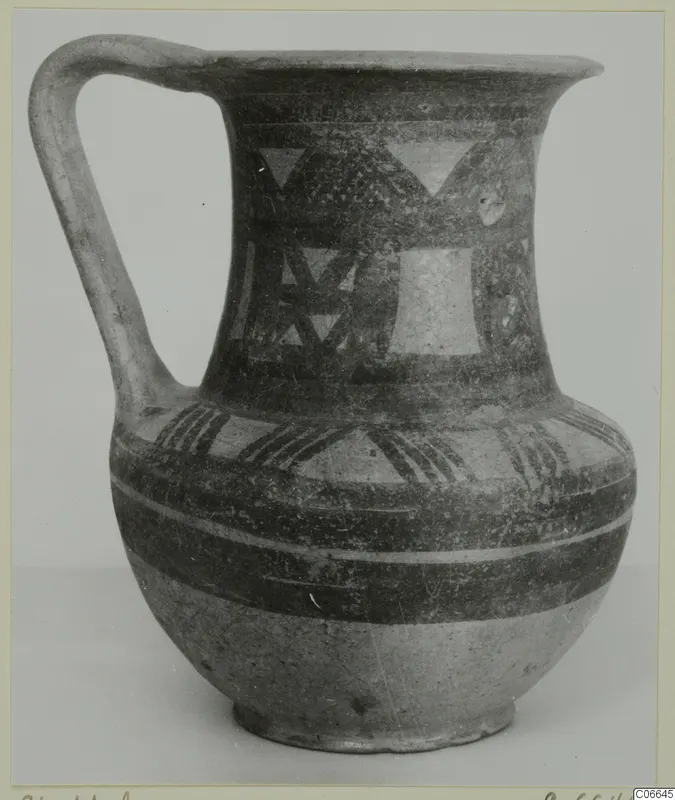 Pottery jug with a single strap handle, flaring mouth and painted triangles and bands, Bichrome Wheel-made