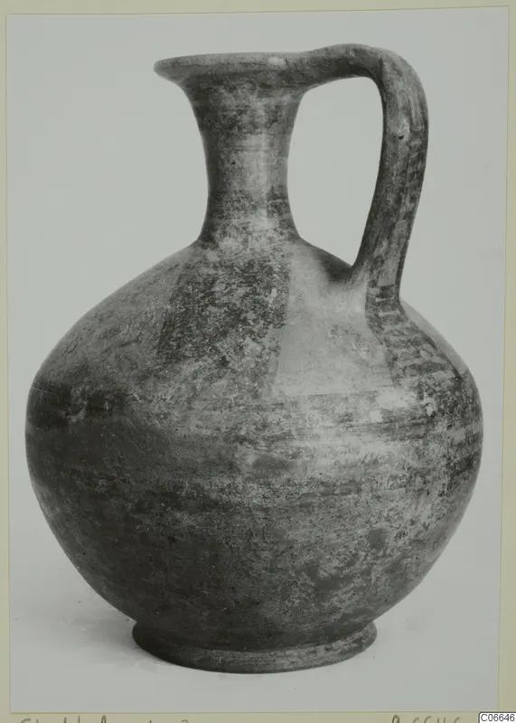 Jug with a single strap handle and flaring neck, shown alone against a pale background