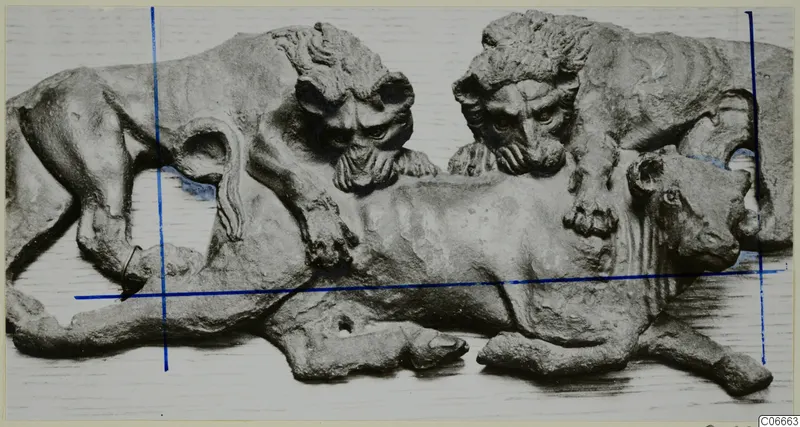 Bronze sculpture group of two lions attacking a bull.