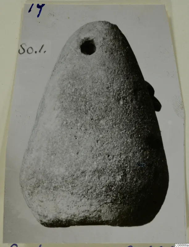 Terracotta loom weight from Soli, tapering with a round hole near the top