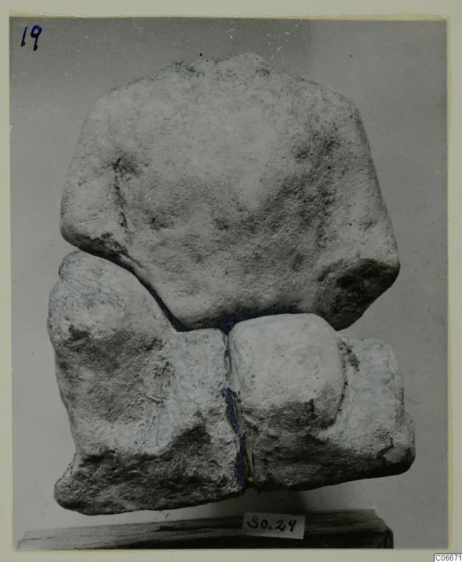 Limestone sculpture fragment from Mersinaki, several pieces fitted together, standing on a wooden base