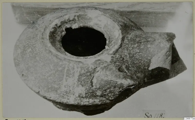Terracotta lamp with a large round filling hole, photographed from above at an angle.