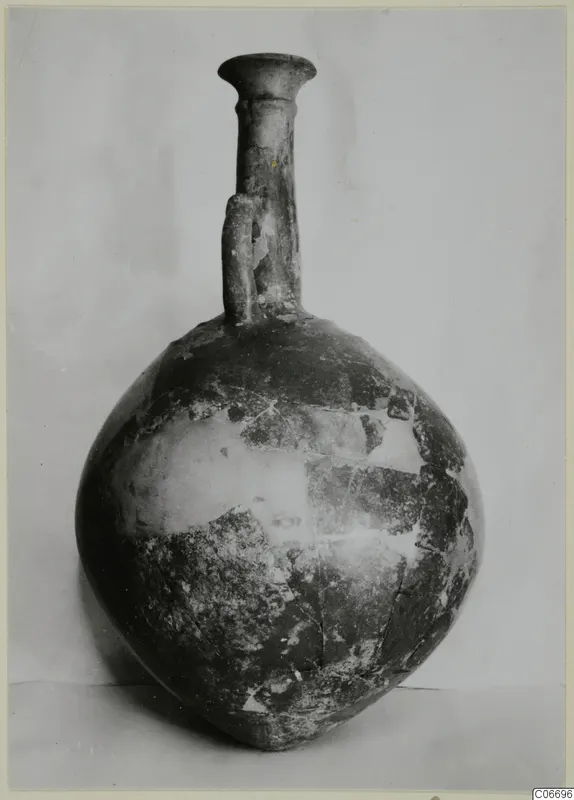 Red Polished II jug with a globular body, tall narrow neck, flared rim and a single vertical handle.