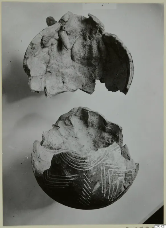 Pottery Red Polished II Jug: two broken pieces of a vessel, the lower one with white painted arcs and chevron lines