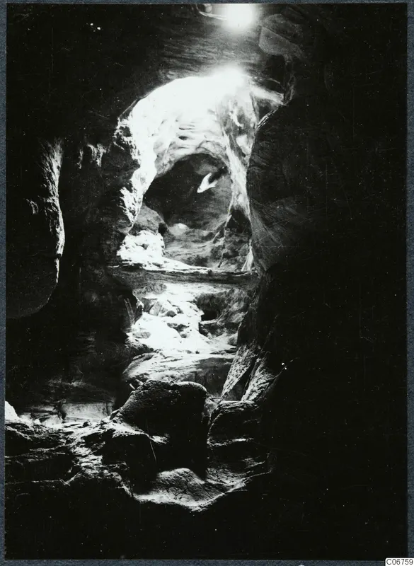 Interior of a rock cave at Kythrea, looking toward a bright opening in the rock.