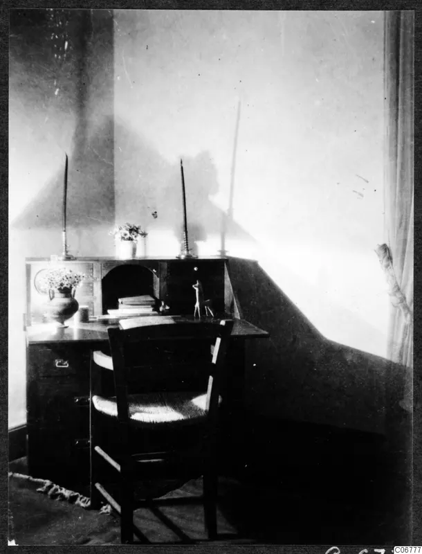 Wooden desk with a roll-top section and chair in the corner of a room in Nicosia