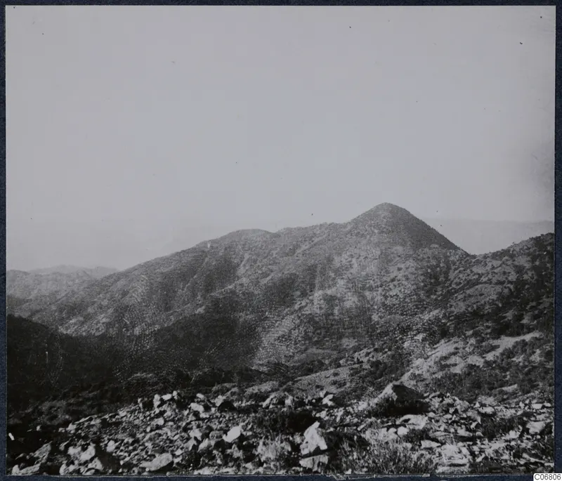Mountain peak above a stony hillside with scrub, at Troodos Machairas