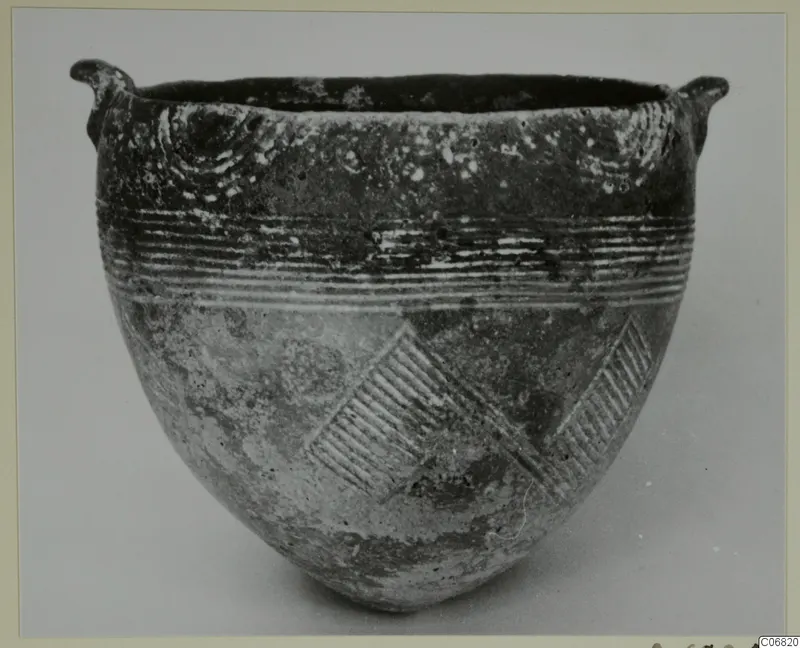 Red Polished I bowl from Lapithos with two small lug handles, grooved horizontal lines and diagonal hatched bands on its body
